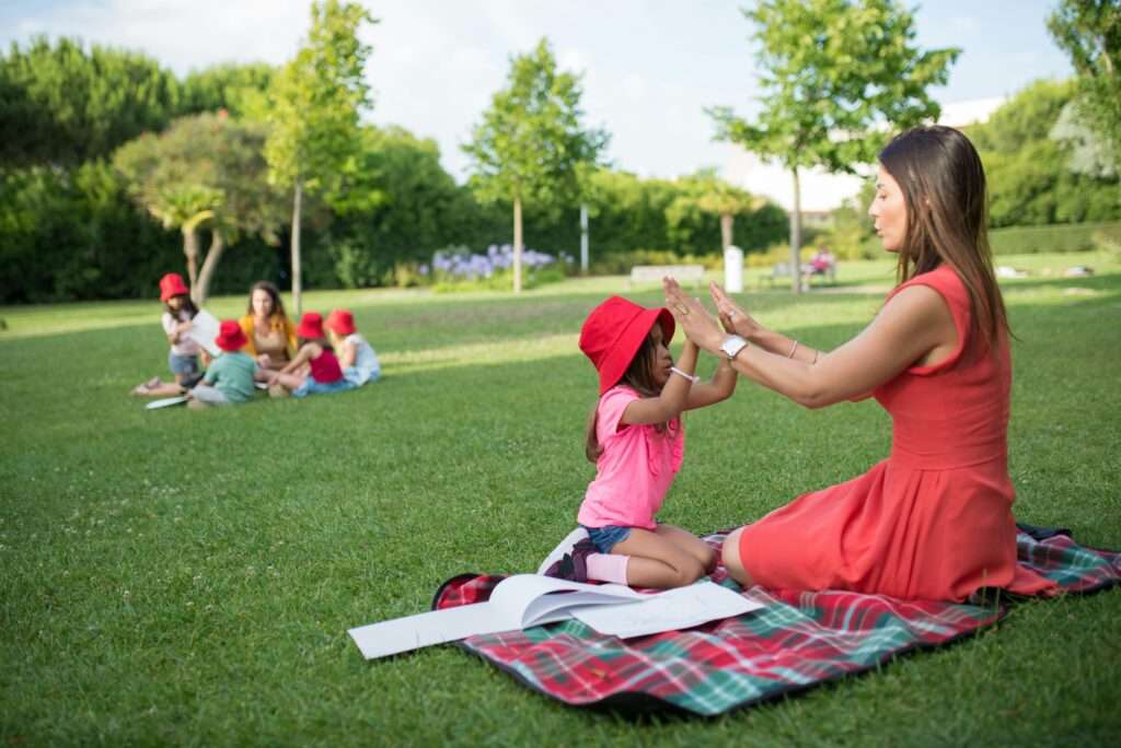 Nanny and girl playing in the park